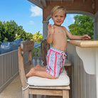 Boys swim trunks : PALM STRIPE - RED. Childrens swimwear designed by Lotty B