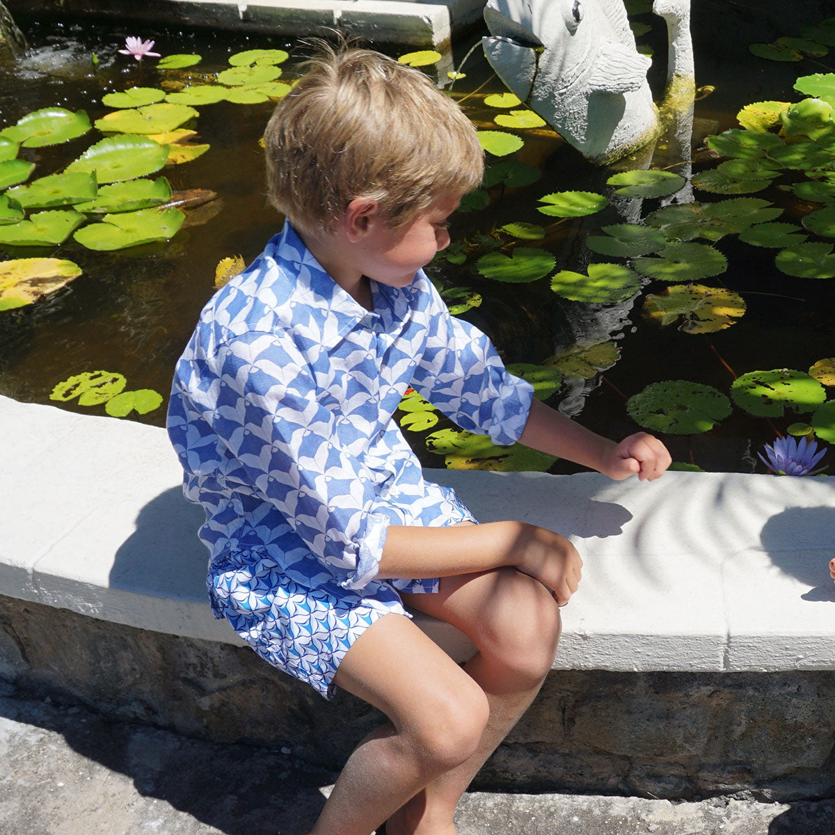 Childrens Linen Shirt: MANTA RAY NAVY sitting by the pond Mustique