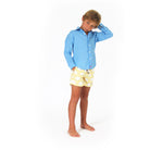 Boys swim trunks : FAN PALM - YELLOW with french blue linen shirt, front