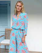 Occasionwear pure silk Kim blouse in Plantation sunset orange and turquoise print worn with matching palazzo pants by designer Lotty B for Pink House