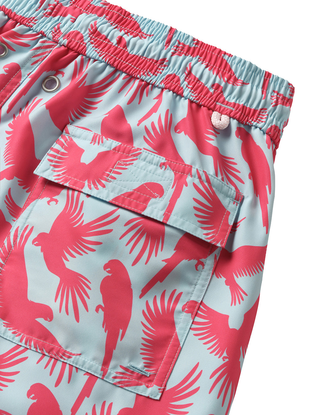 Back pocket detail of men's swim shorts in coral and turquoise blue Parrot print, recycled fabric by Pink House 