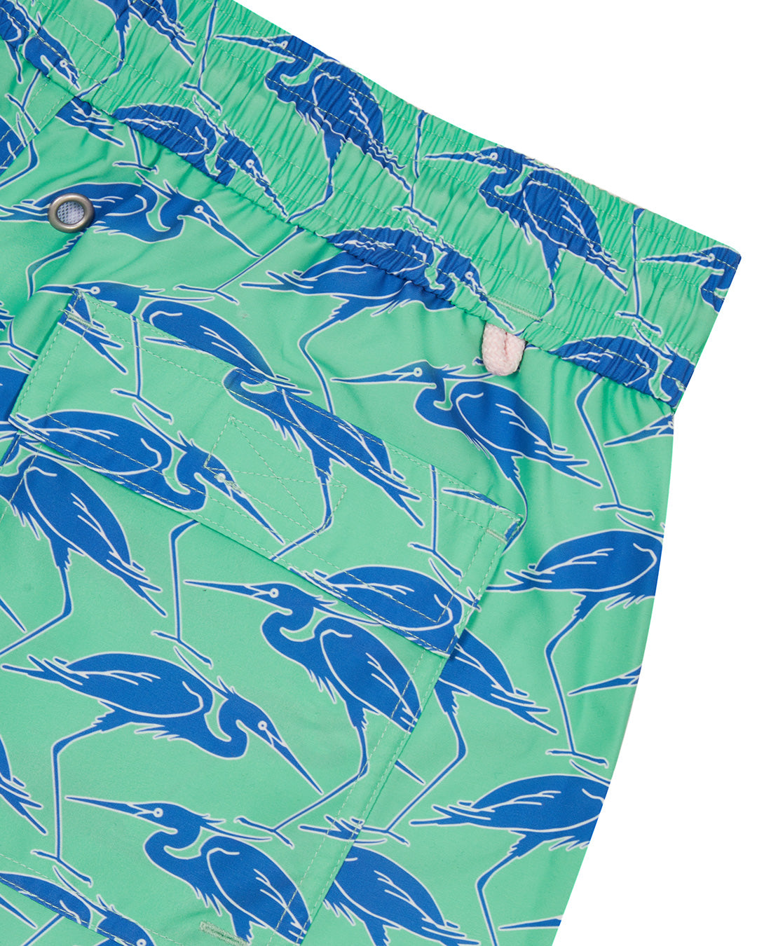 Pocket detail of sustainable Mens swim shorts in green & blue Egret bird print by Lotty B Mustique