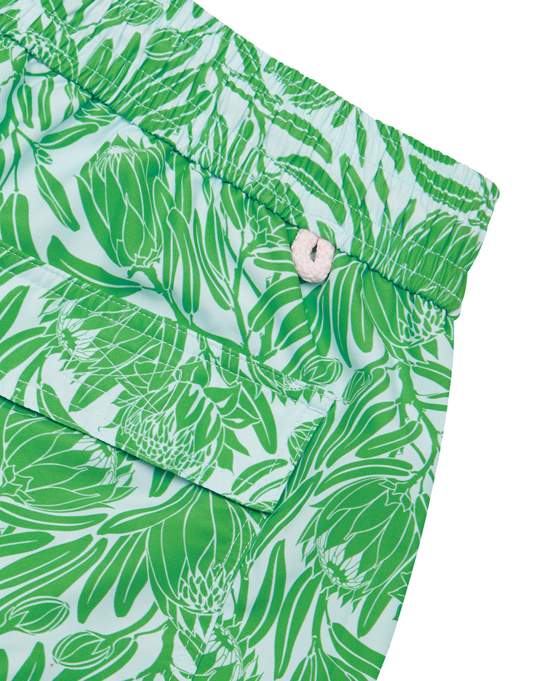 Back pocket detail of men's recycled swim trunks in green Protea print by Lotty B for Pink House