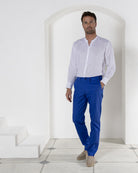 Men's vacation fashion, linen pants in dazzling blue worn with classic collarless white linen shirt. Resortwear by Pink House 