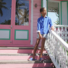 Shopping in the Pink House boutique on Mustique island in dazzling blue linen shirt