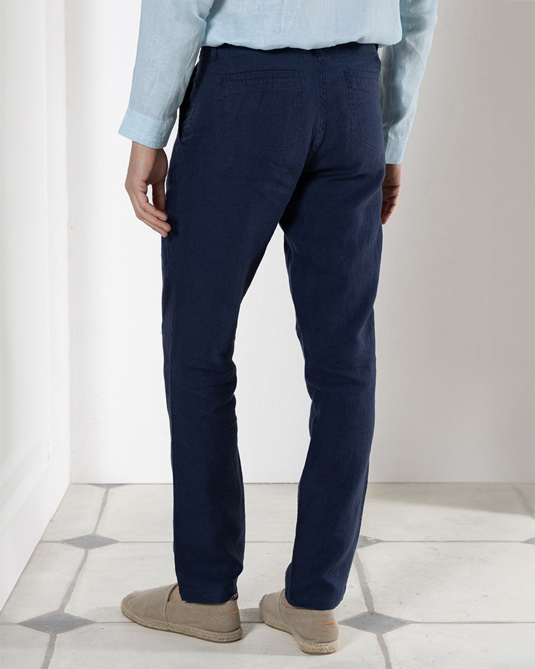 Designer pure linen pants in eclipse navy blue worn with pale blue linen shirt