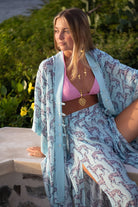 Elegant silk Jade poncho in Lurcher aubergine pale blue print worn with matching palazzo pants model Ella Fanshawe