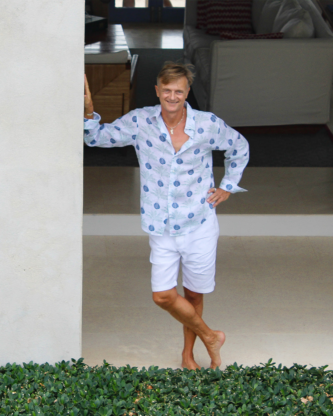 Chic holiday style in a Mustique villa in a pure linen shirt in green and navy blue Potted Palm print by designer Lotty B for Pink House