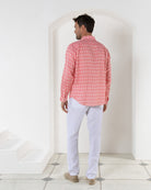 Drawstring white linen pants worn with striped shell pink print shirt by Pink House resortwear