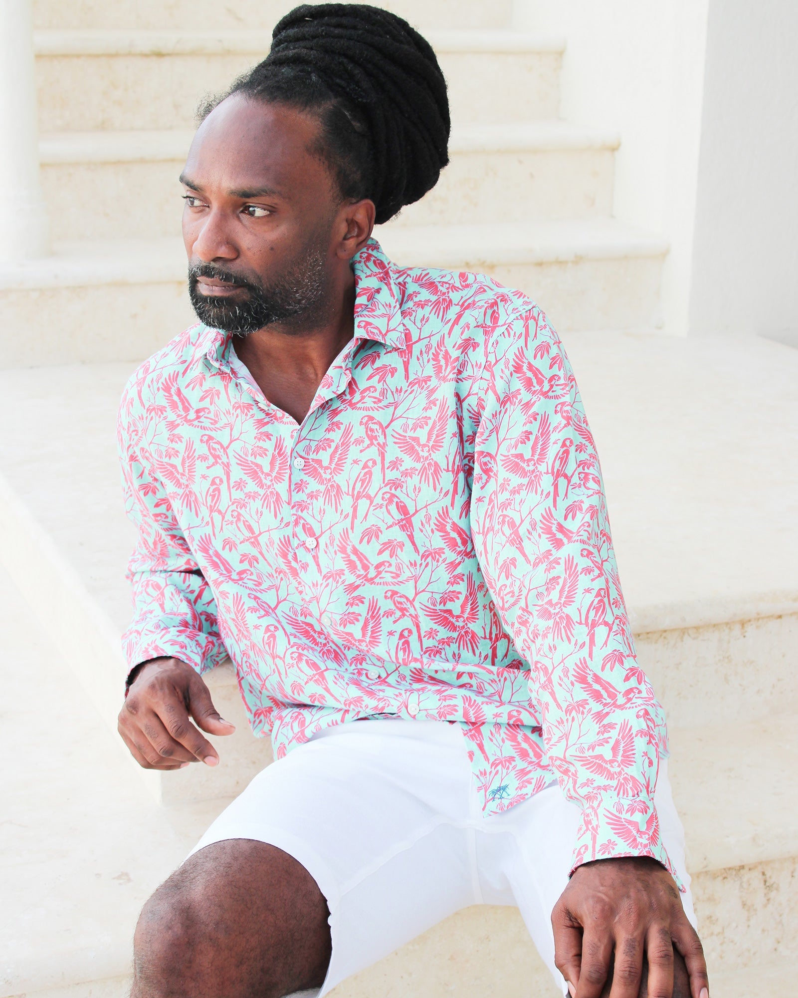 Island style men's linen shirt in coral and turquoise Parrot print designer Lotty B Mustique