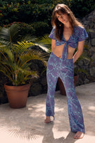 Luxury resort fashion fit & flare silk trousers in Protea violet & turquoise print by designer Lotty B