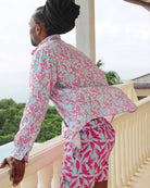 Vacation style men's linen shirt in coral and turquoise Parrot print designer Lotty B Mustique